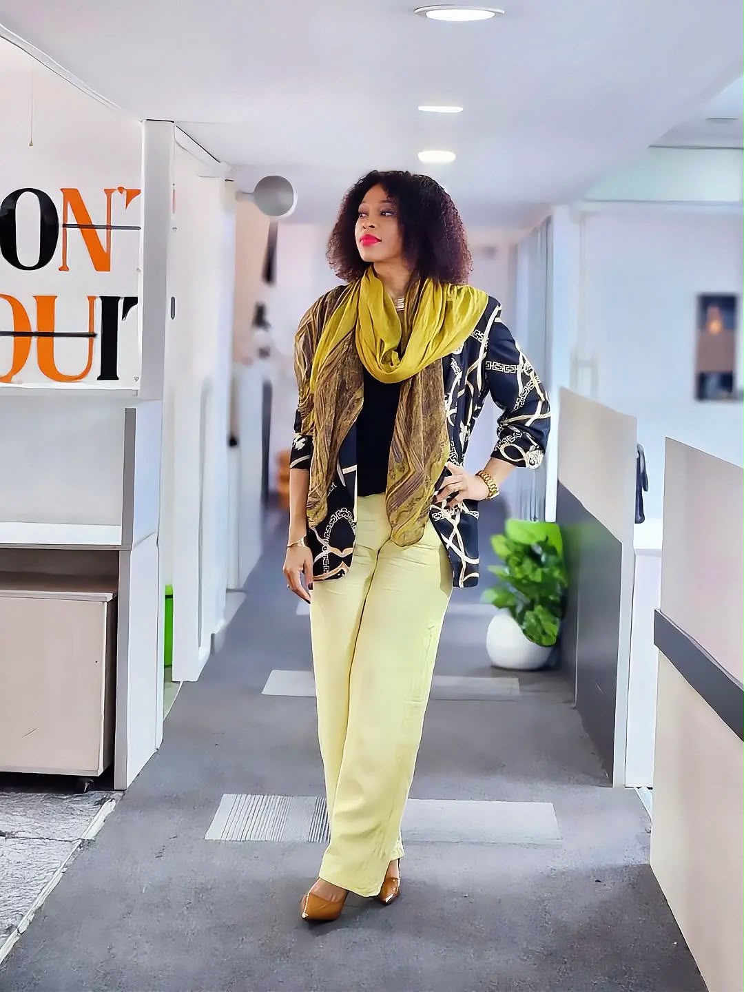 Amabelle walking confidently through an office corridor